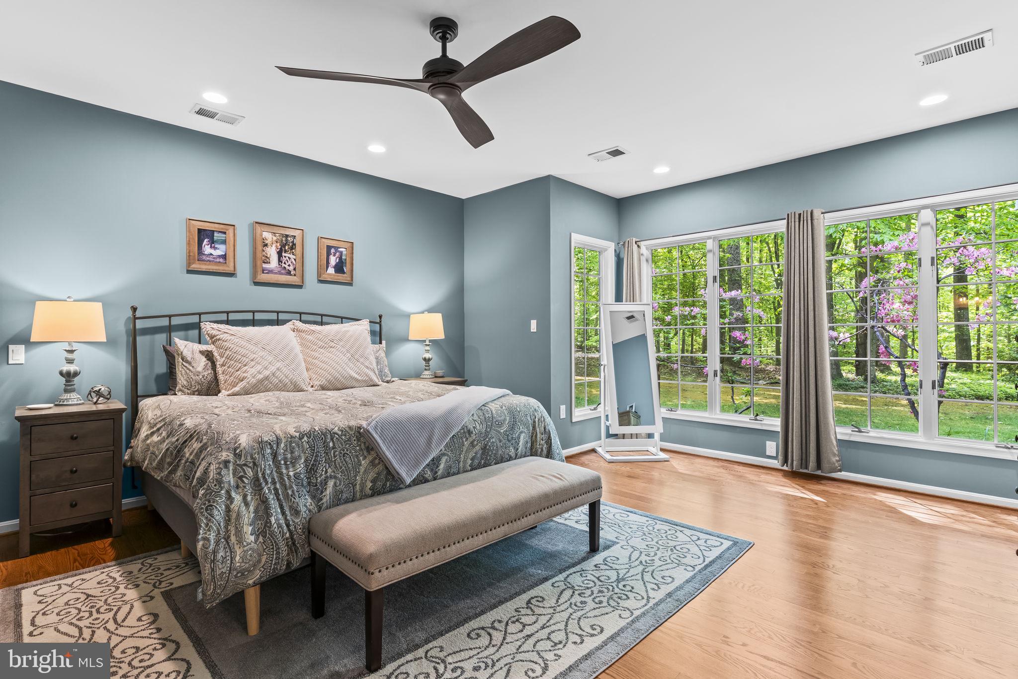 4111 Buck Board Lane Dunkirk, MD 20754 - Photo 26 of 74 a spacious bedroom with a bed a couch and a large window