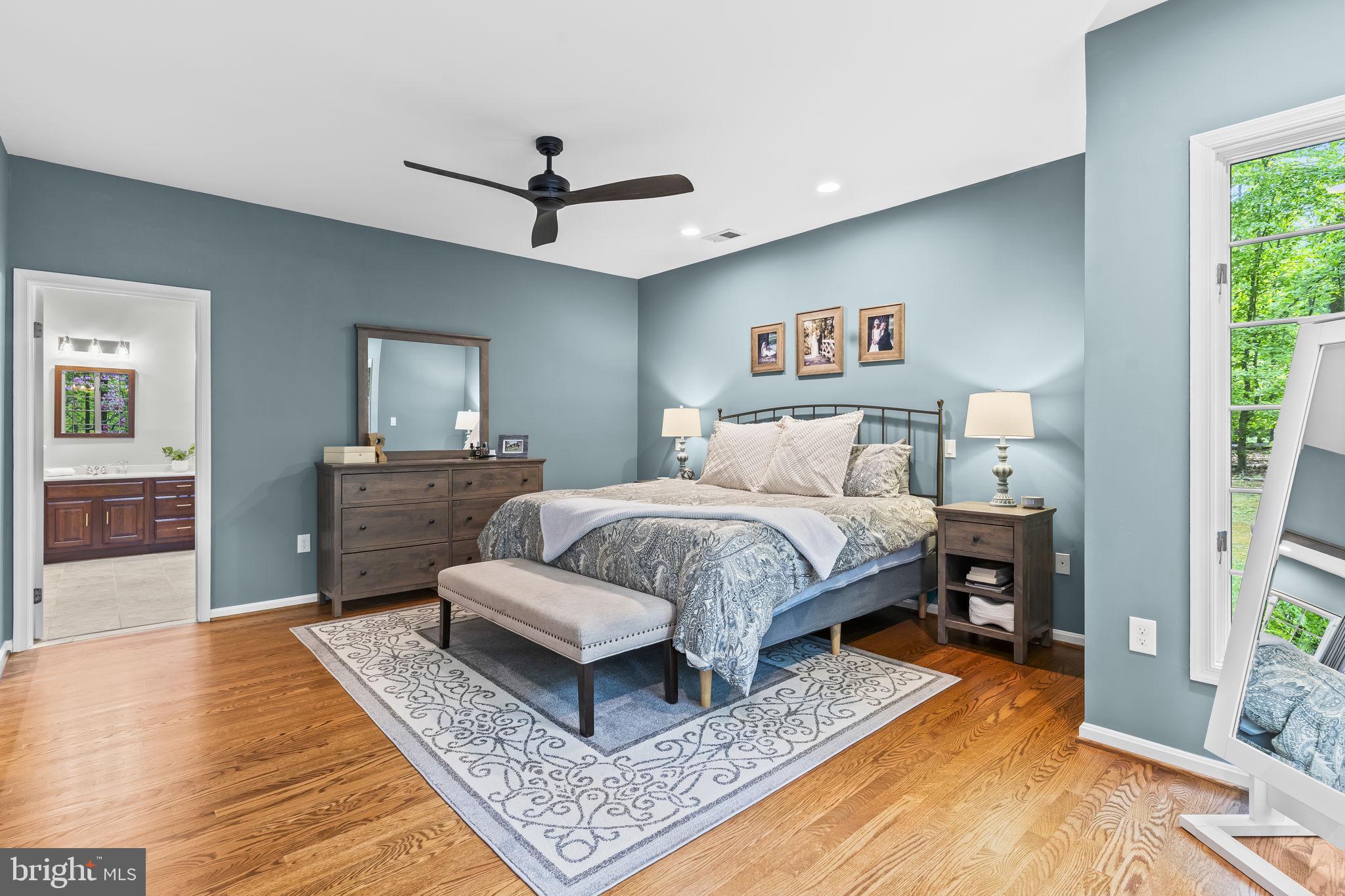 4111 Buck Board Lane Dunkirk, MD 20754 - Photo 28 of 74 a spacious bedroom with a bed a dresser and wooden floor