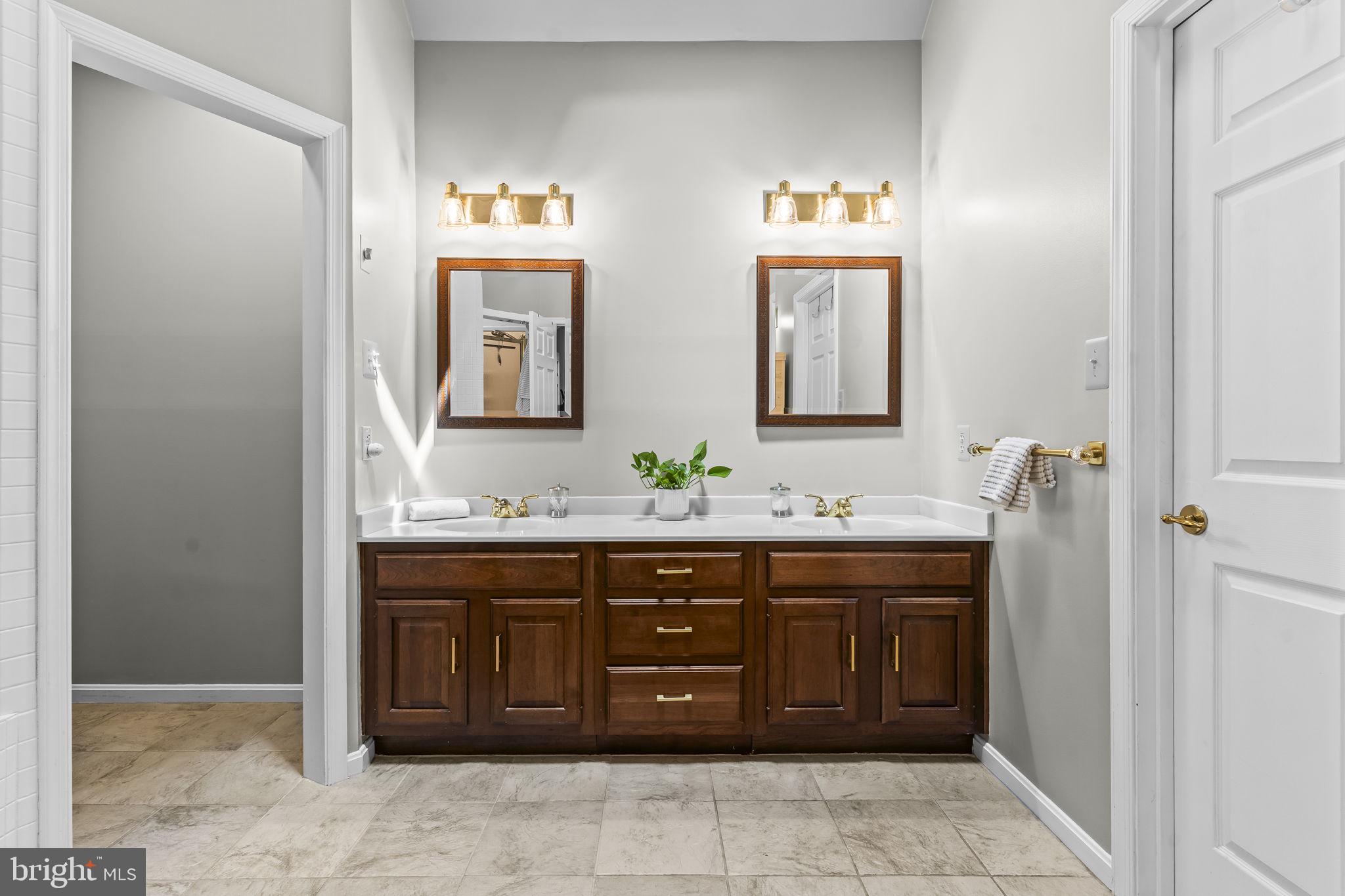 4111 Buck Board Lane Dunkirk, MD 20754 - Photo 29 of 74 a spacious bathroom with a granite countertop sink and a mirror