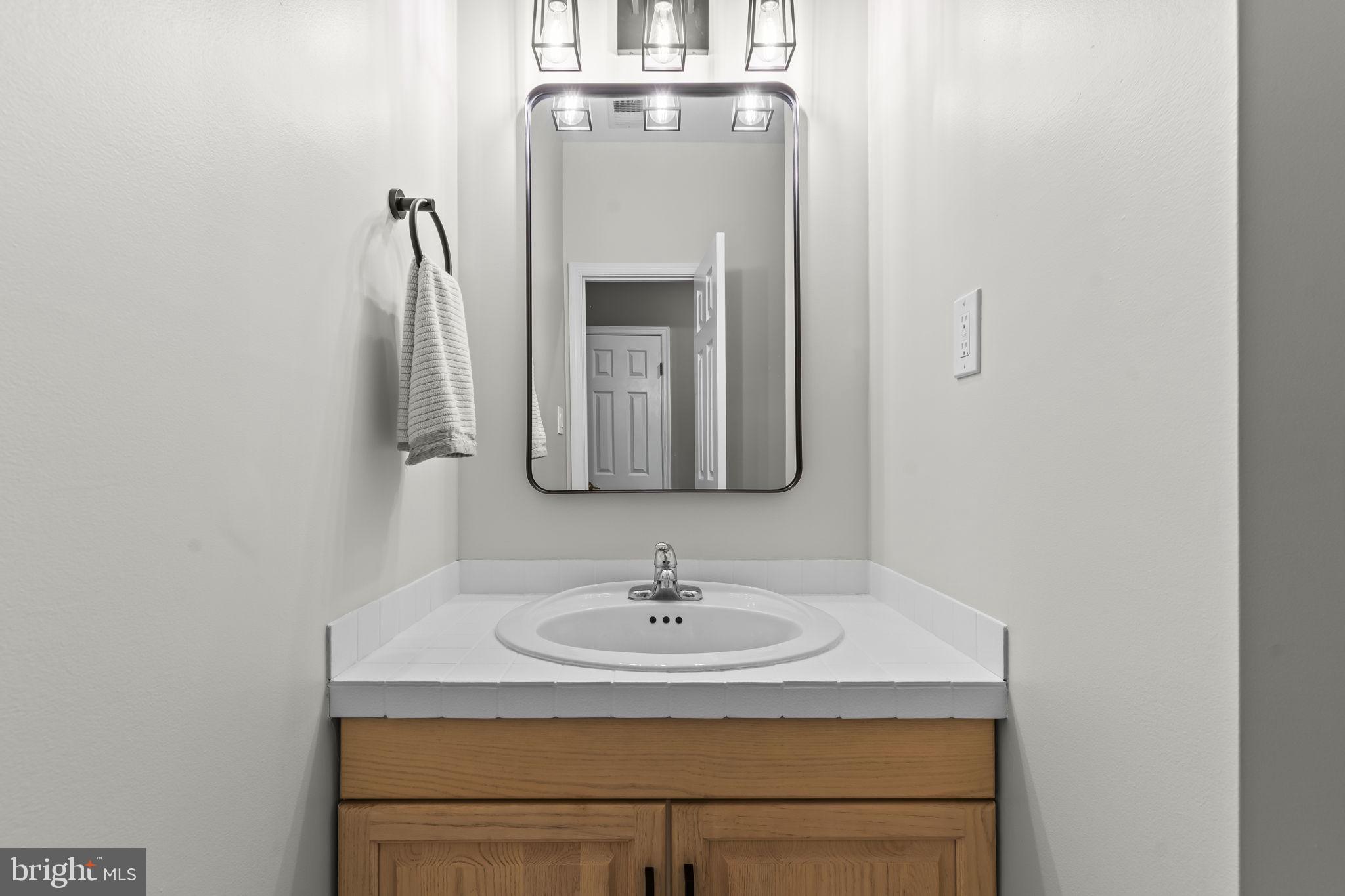 4111 Buck Board Lane Dunkirk, MD 20754 - Photo 45 of 74 a bathroom with a sink and a mirror