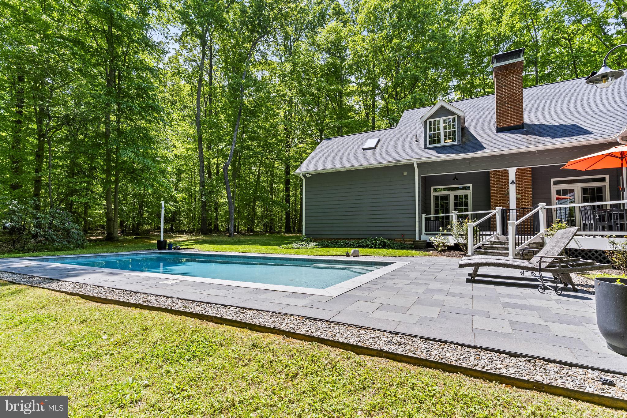 4111 Buck Board Lane Dunkirk, MD 20754 - Photo 49 of 74 a view of pool with lawn chairs and large trees