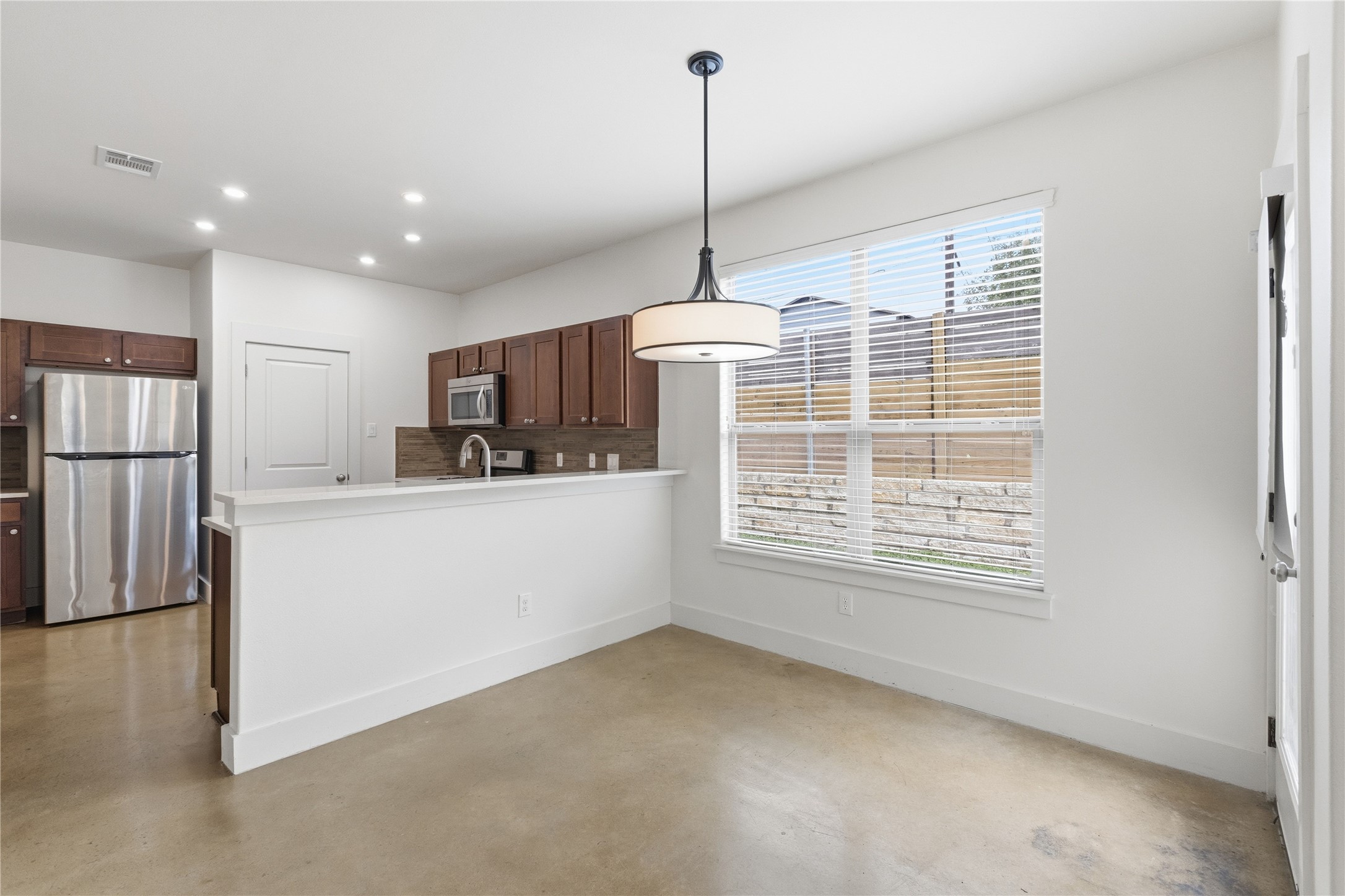 4124 Valley View Road, Unit 4A & 4B Austin, TX 78704 - Photo 5 of 40 An open-concept living area with a sleek kitchen and abundant natural illumination from a large window.