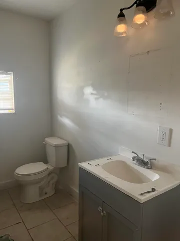a kitchen with a sink cabinets and window