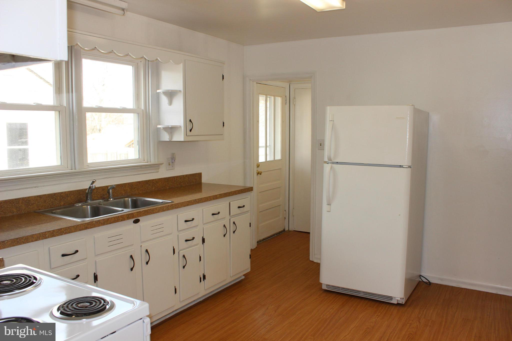 100 North Reymann Street Ranson, WV 25438 - Photo 6 of 16 Kitchen with Refrigerator and Stove