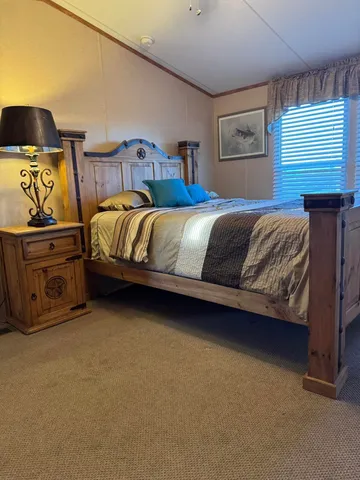 a bedroom with a bed and cabinets