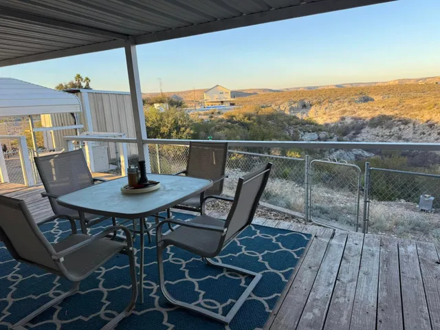 a view of a balcony with table and chairs