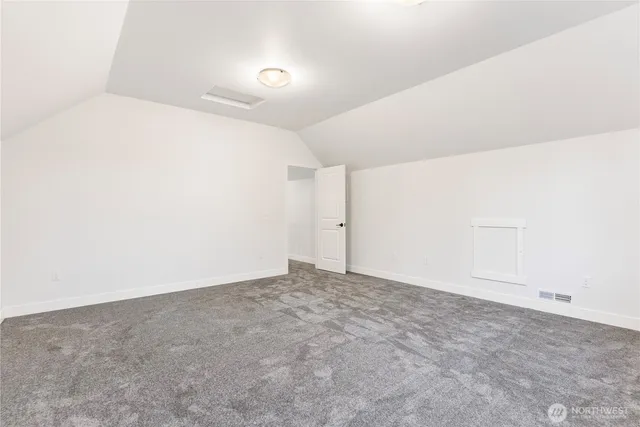 a bathroom with a bathtub shower sink vanity mirror and toilet
