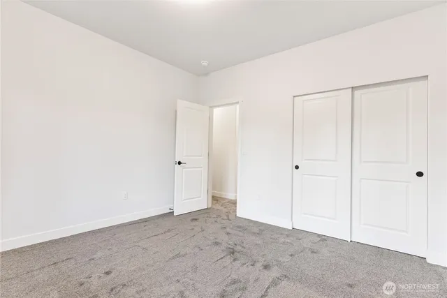 a bathroom with a granite countertop toilet and a sink