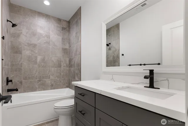 a bathroom with a tub double sink and mirror