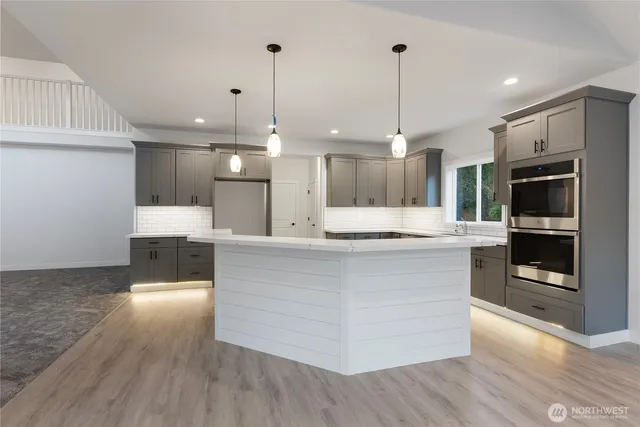 a kitchen with stainless steel appliances granite countertop a sink and stove top oven