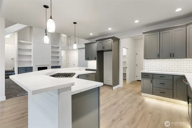 a bathroom with a sink a toilet a mirror and shower