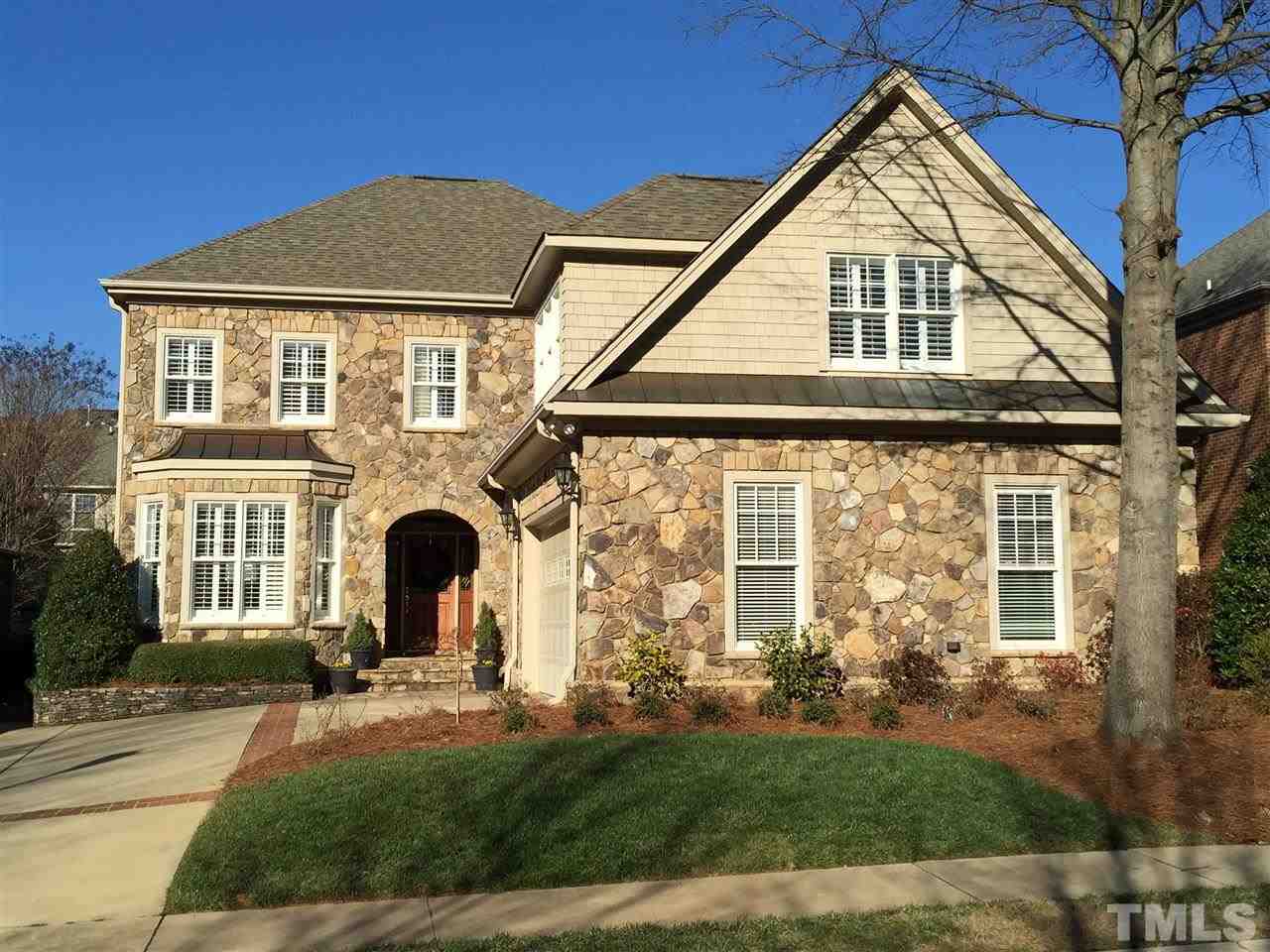 a view of a brick house with a yard