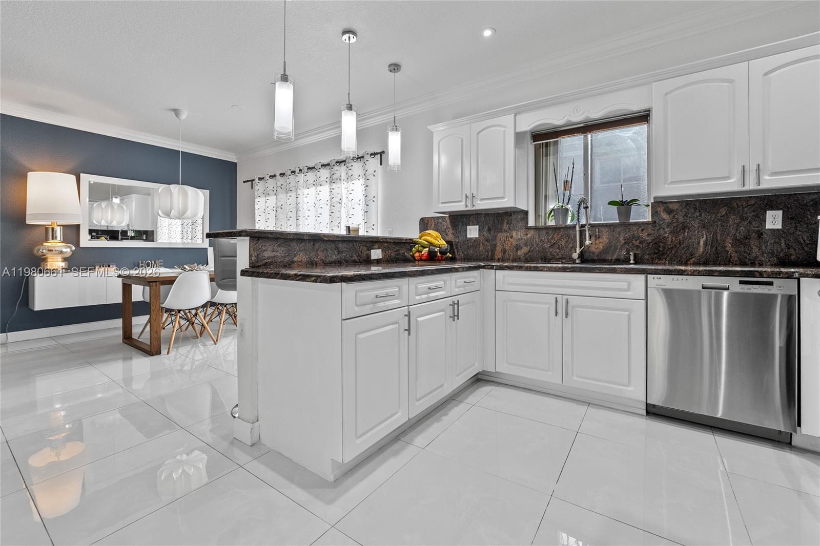 21474 Southwest 85th Path Cutler Bay, FL 33189 - Photo 11 of 30 a kitchen with white cabinets and sink