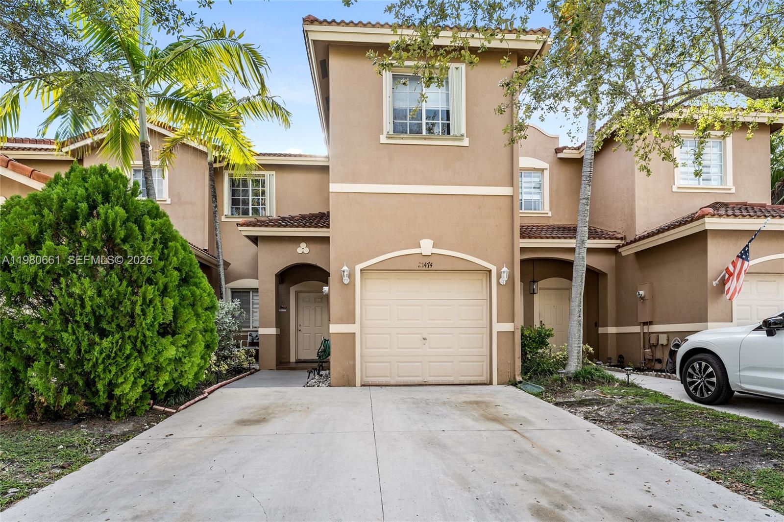 21474 Southwest 85th Path Cutler Bay, FL 33189 - Photo 2 of 30 a couple of cars parked in front of a house