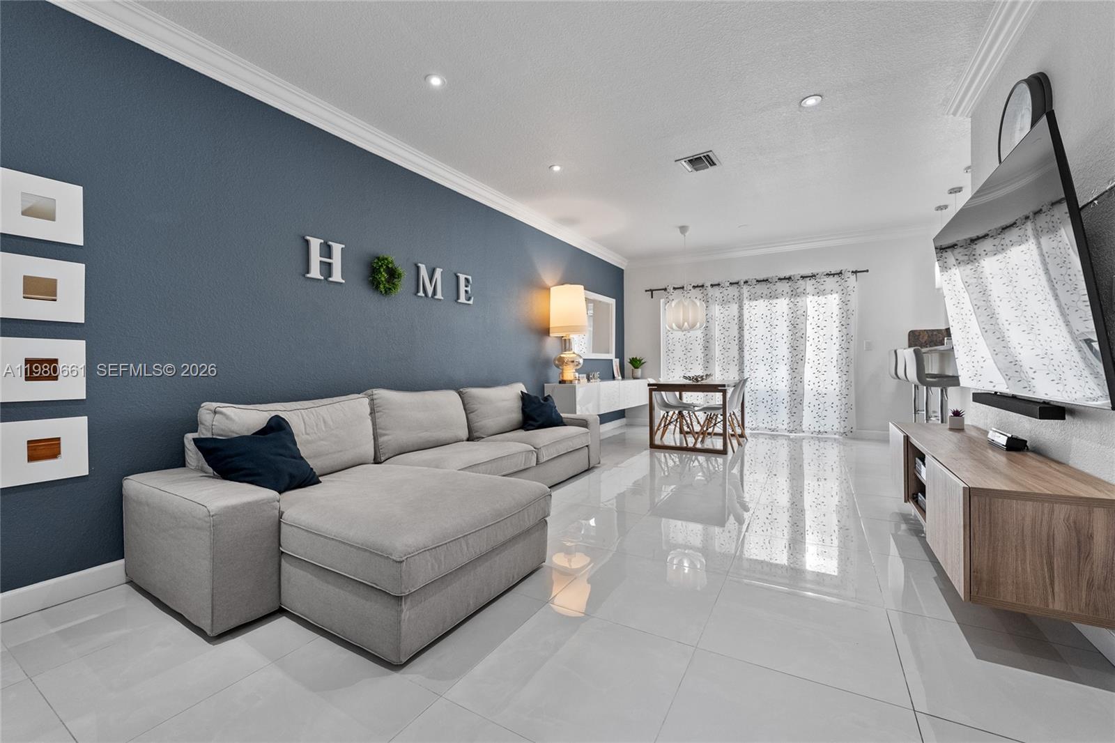 21474 Southwest 85th Path Cutler Bay, FL 33189 - Photo 4 of 30 a living room with furniture and a flat screen tv
