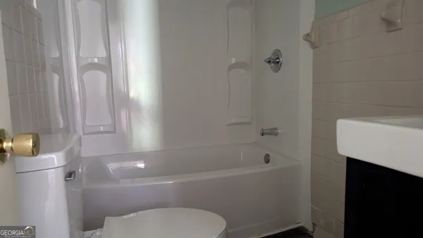 a bathroom with a toilet and a bathtub