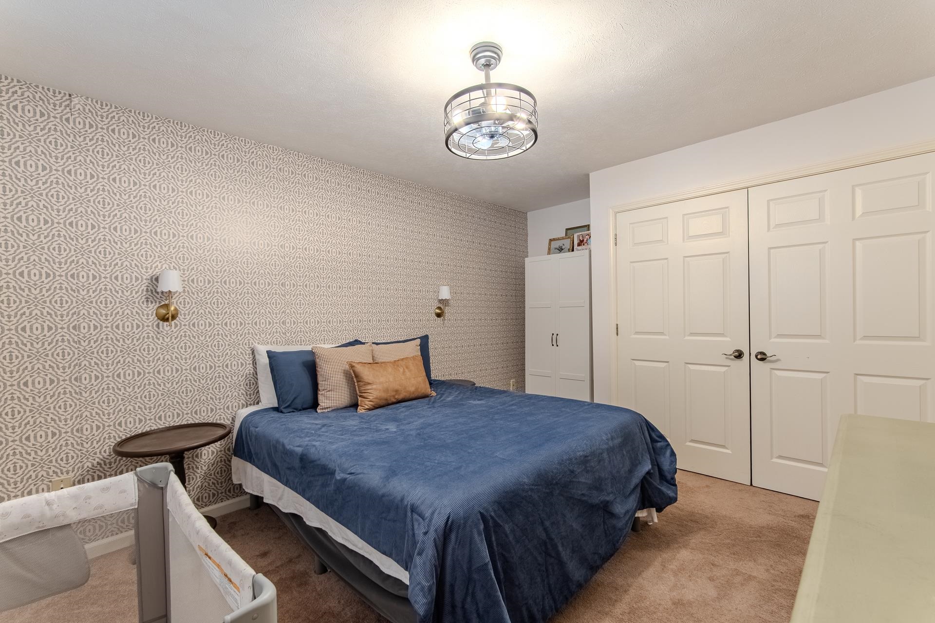 215 St Andrew's Court Counce, TN 38326 - Photo 15 of 37 a bedroom with a bed and a chandelier