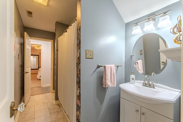a en suite bathroom with a sink and mirror