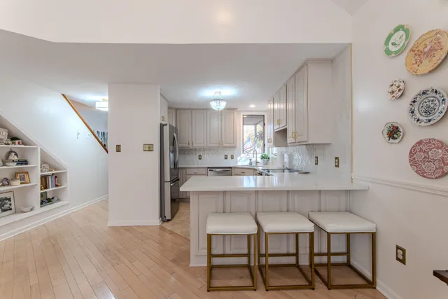 a kitchen with cabinets and chairs