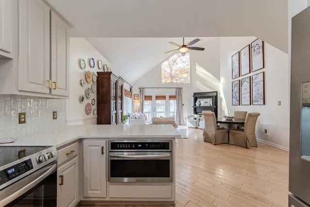 a kitchen with stainless steel appliances granite countertop a stove and cabinets