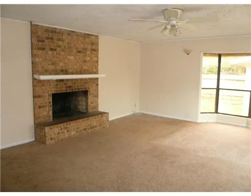 a view of empty room with fireplace
