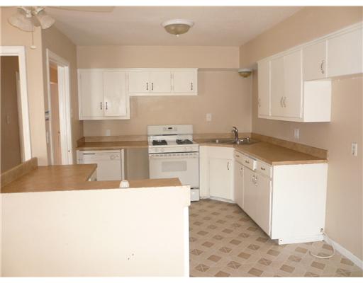 4013 Cott Street Corpus Christi, TX 78411 - Photo 4 of 7 a kitchen with a sink stove and white cabinets