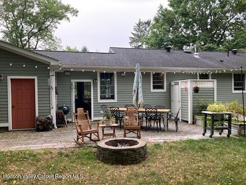 14 Knoth Road Wallkill, NY 12589 - Photo 40 of 46 a backyard of a house with fire pit and outdoor seating