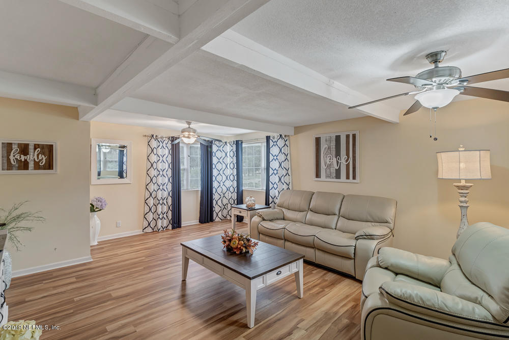 6026 Temple Road Jacksonville, FL 32217 - Photo 4 of 13 a living room with furniture and a wooden floor