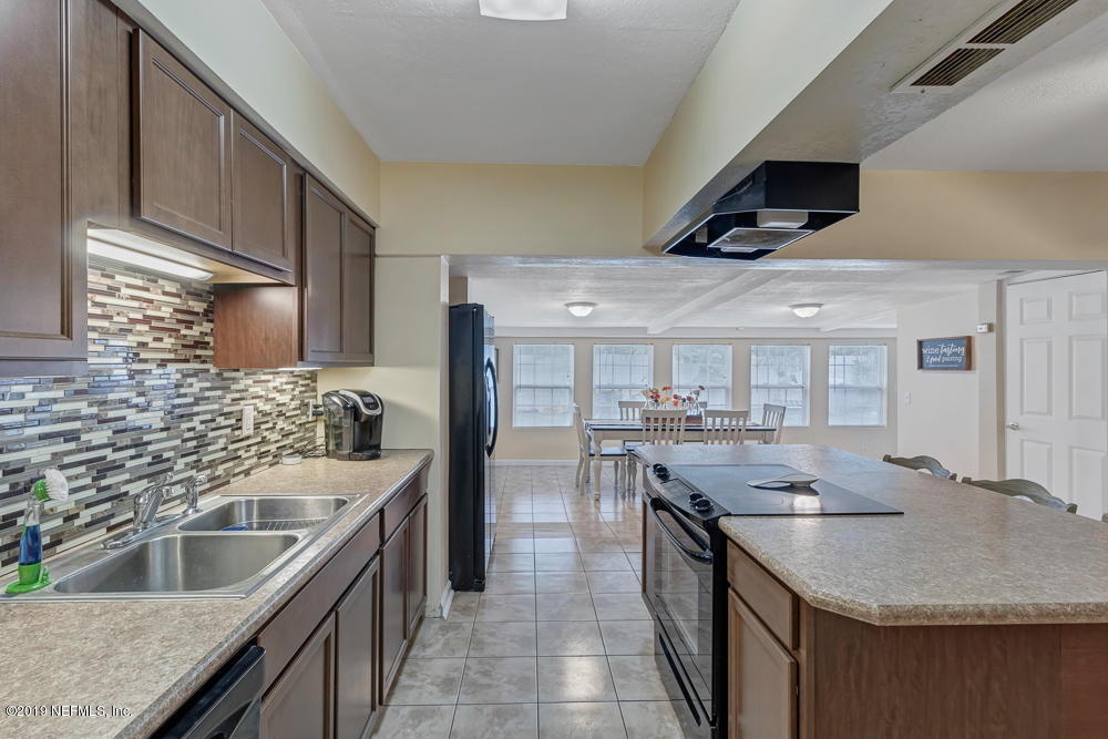 6026 Temple Road Jacksonville, FL 32217 - Photo 9 of 13 a kitchen with a stove sink and cabinets