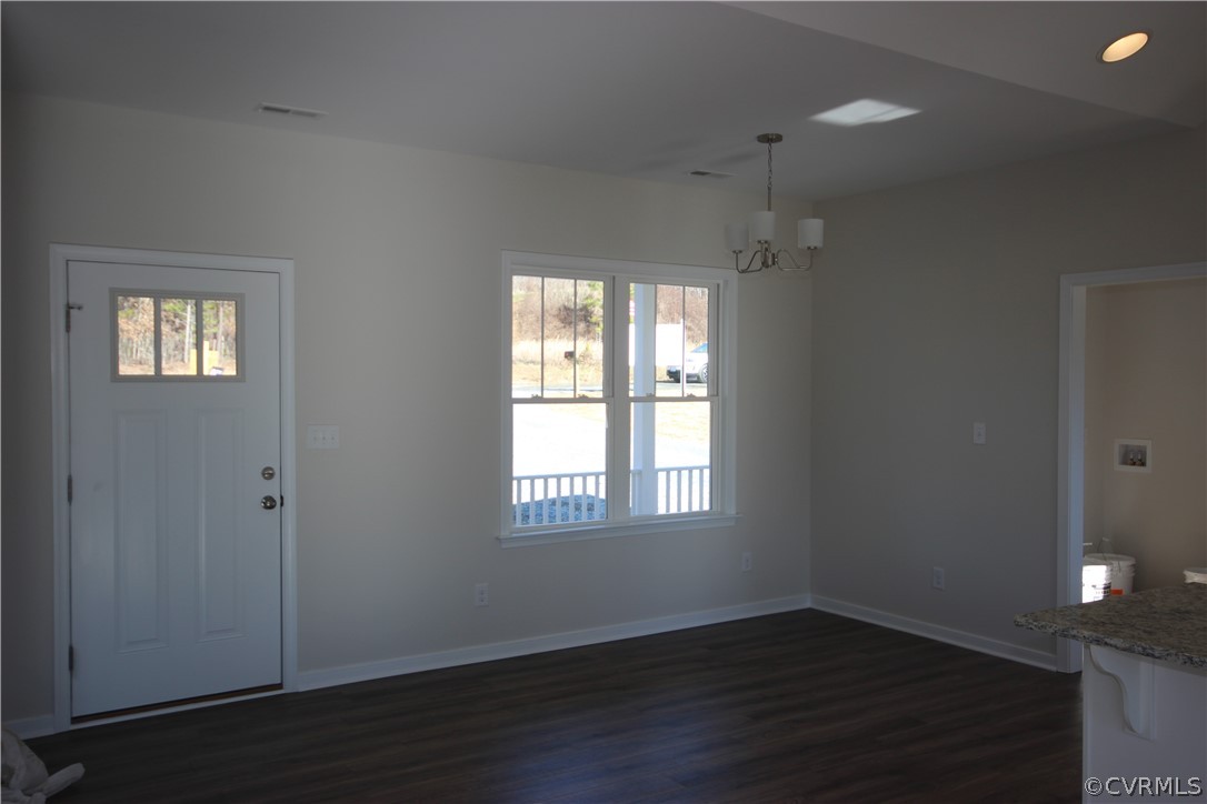 209 New S Ridge Road Bumpass, VA 23024 - Photo 11 of 26 an empty room with wooden floor and windows