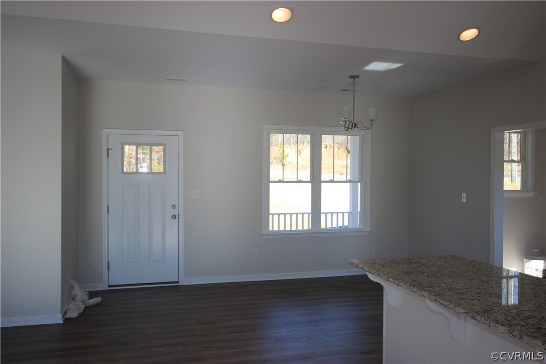 209 New S Ridge Road Bumpass, VA 23024 - Photo 6 of 26 an empty room with wooden floor and windows