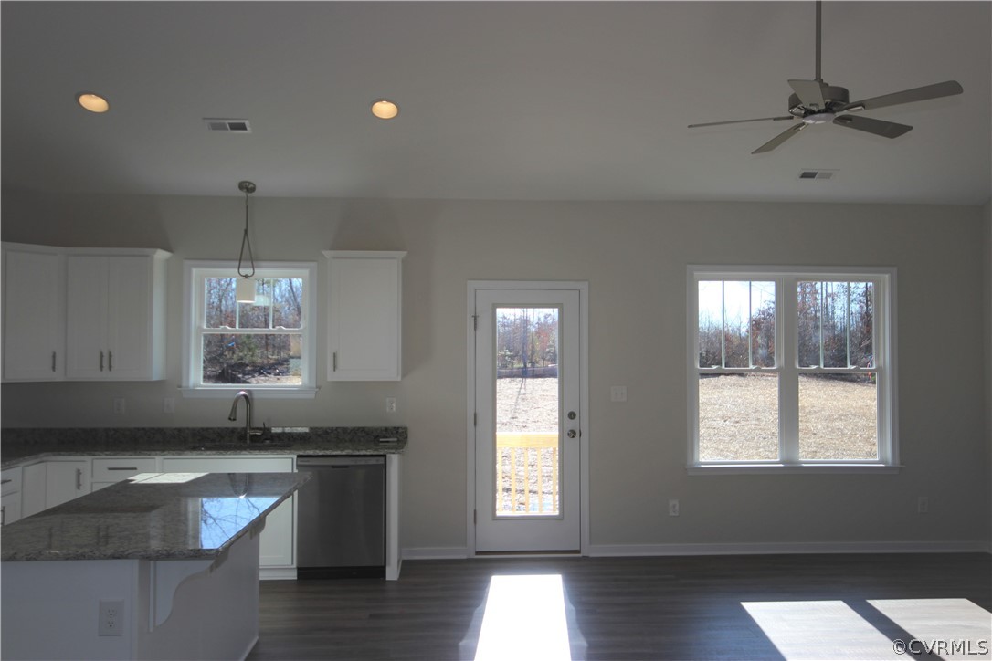 209 New S Ridge Road Bumpass, VA 23024 - Photo 10 of 26 a kitchen with granite countertop a stove a sink and a window
