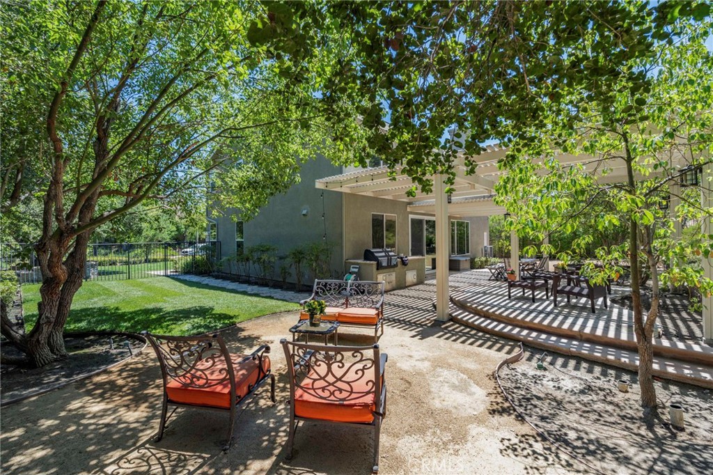 2 Swallows Lane Trabuco Canyon, CA 92679 - Photo 22 of 71 a view of a patio with couches table and chairs and a big yard