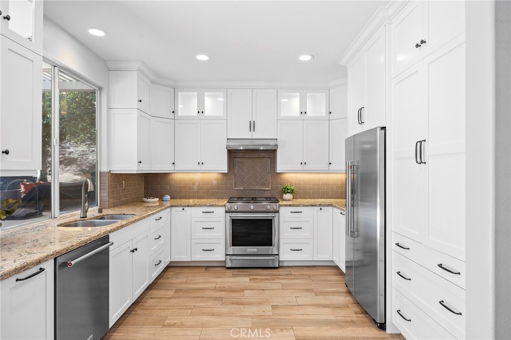2 Swallows Lane Trabuco Canyon, CA 92679 - Photo 30 of 71 a kitchen with stainless steel appliances granite countertop a stove and a refrigerator