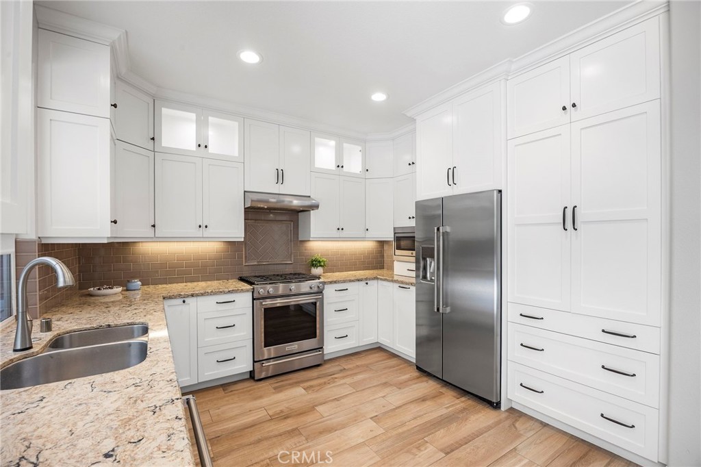 2 Swallows Lane Trabuco Canyon, CA 92679 - Photo 32 of 71 a kitchen with granite countertop a sink stove and refrigerator