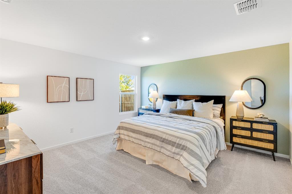 1263 Maple Street Wilmer, TX 75172 - Photo 13 of 22 a bedroom with a bed and window