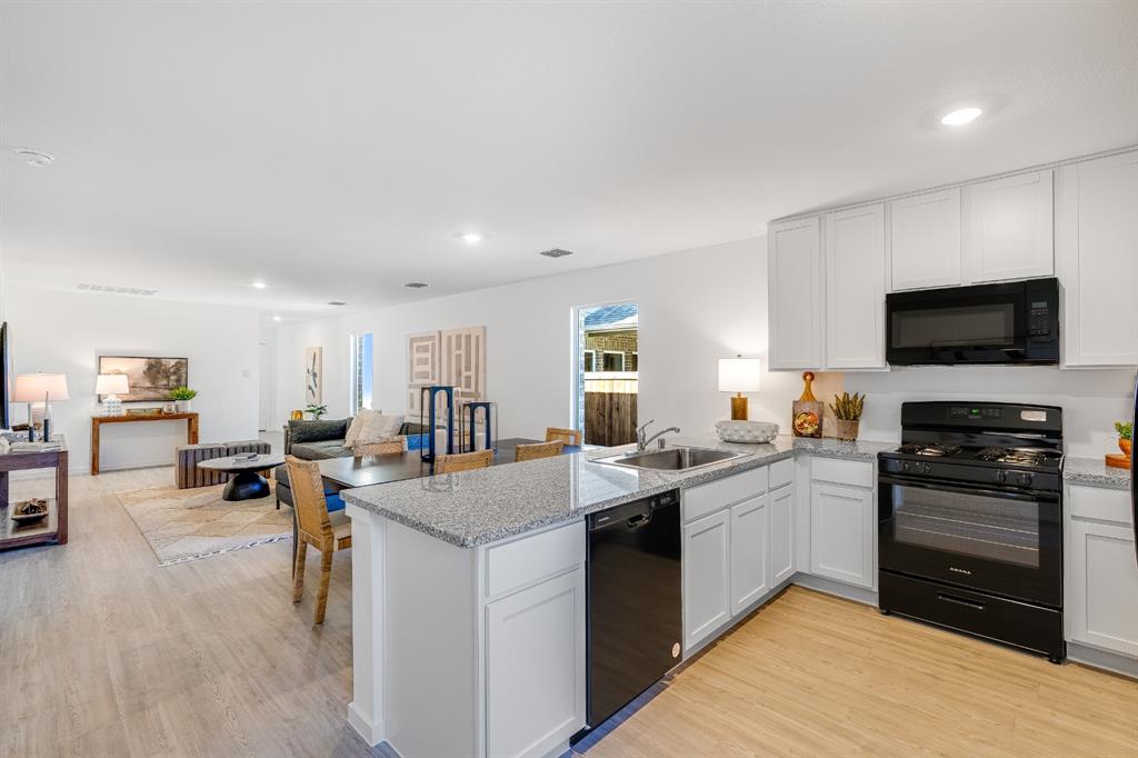 1263 Maple Street Wilmer, TX 75172 - Photo 21 of 22 a kitchen with sink a counter top space and appliances