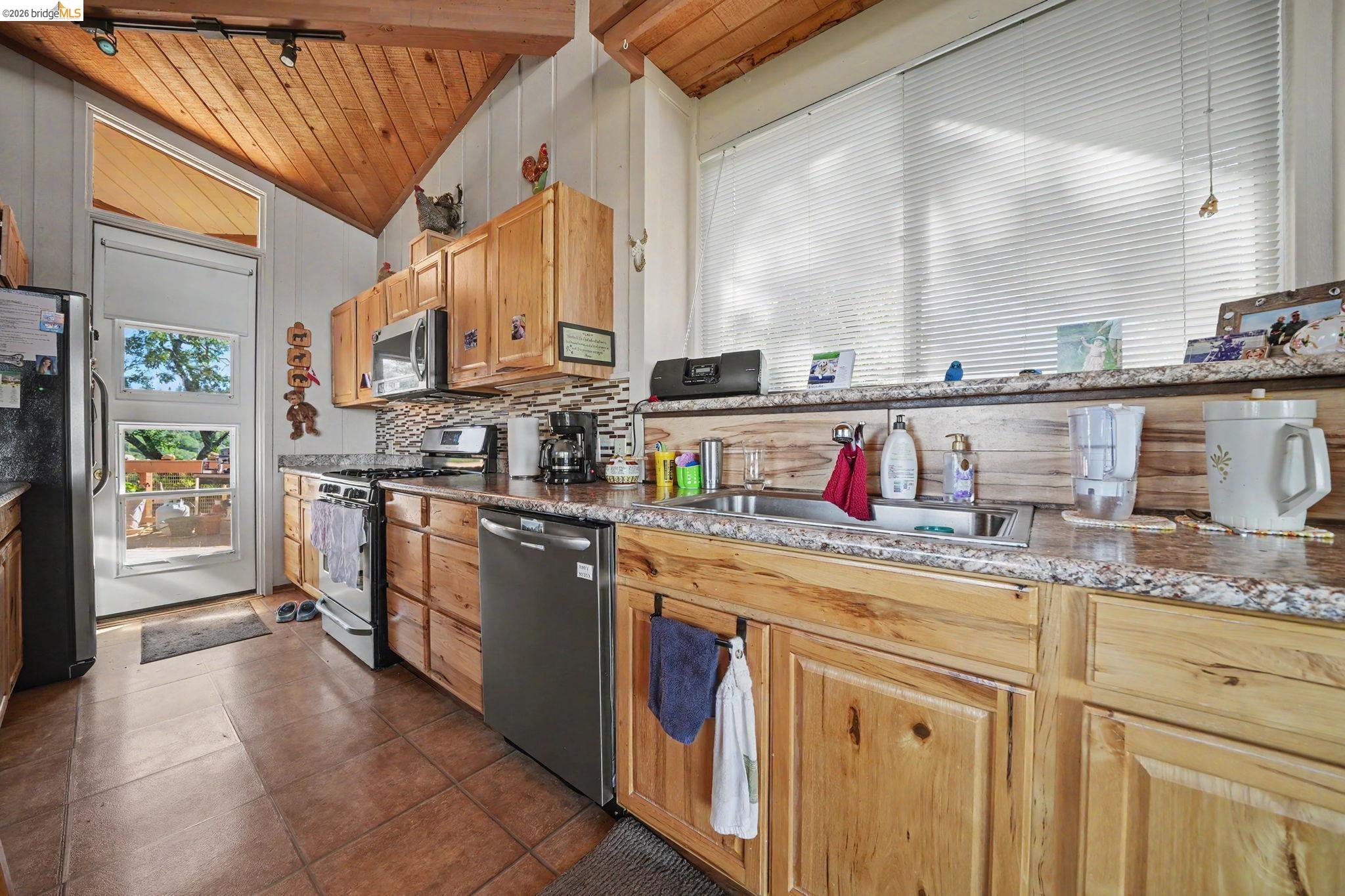 6161 Fullen Road Murphys, CA 95247 - Photo 30 of 53 a kitchen with stainless steel appliances granite countertop a stove and cabinets