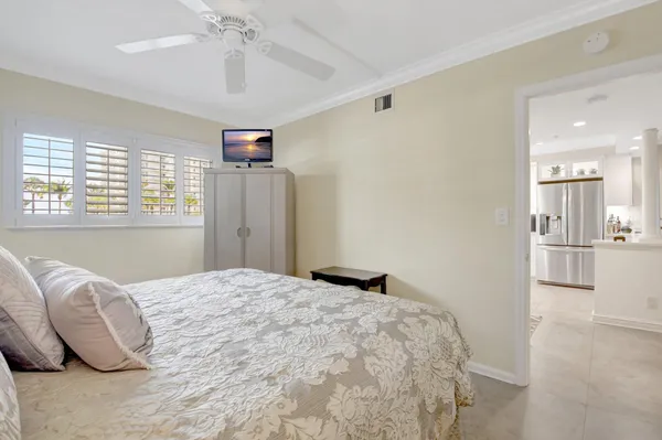 a bedroom with a bed and ceiling fan