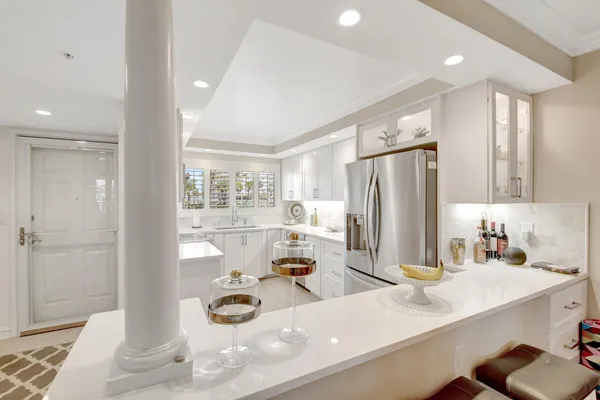 a kitchen with stainless steel appliances a sink and a refrigerator