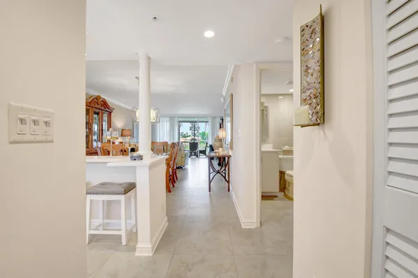 a view of a hallway with dining area closet and livingroom view