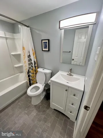 a white toilet sitting next to a bathroom sink