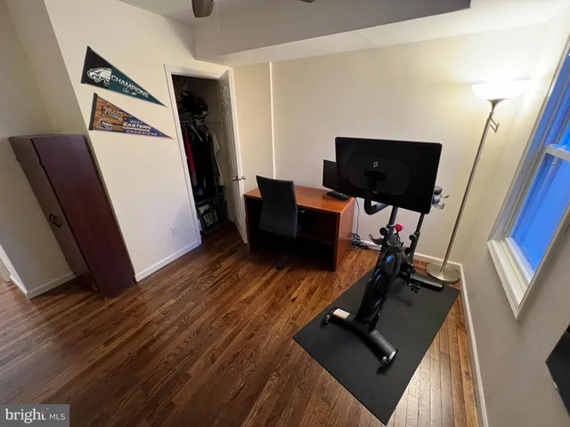 a view of workspace with wooden floor windows