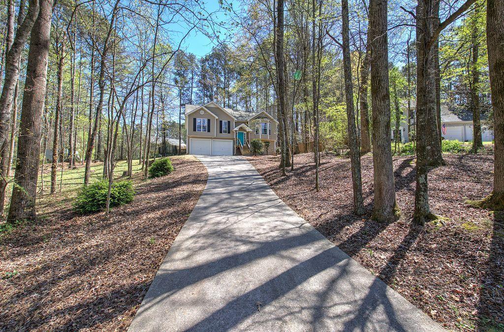 205 Cryder Lane Canton, GA 30115 - Photo 1 of 38 a view of a house with a yard and trees