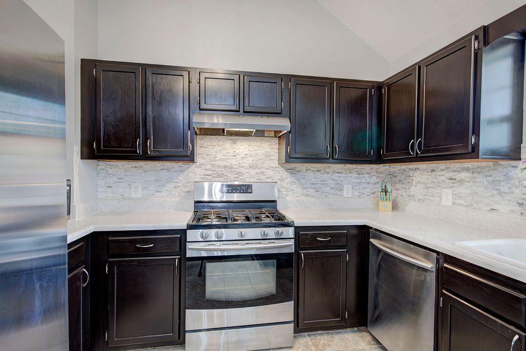205 Cryder Lane Canton, GA 30115 - Photo 15 of 38 a kitchen with wooden cabinets and a stove top oven