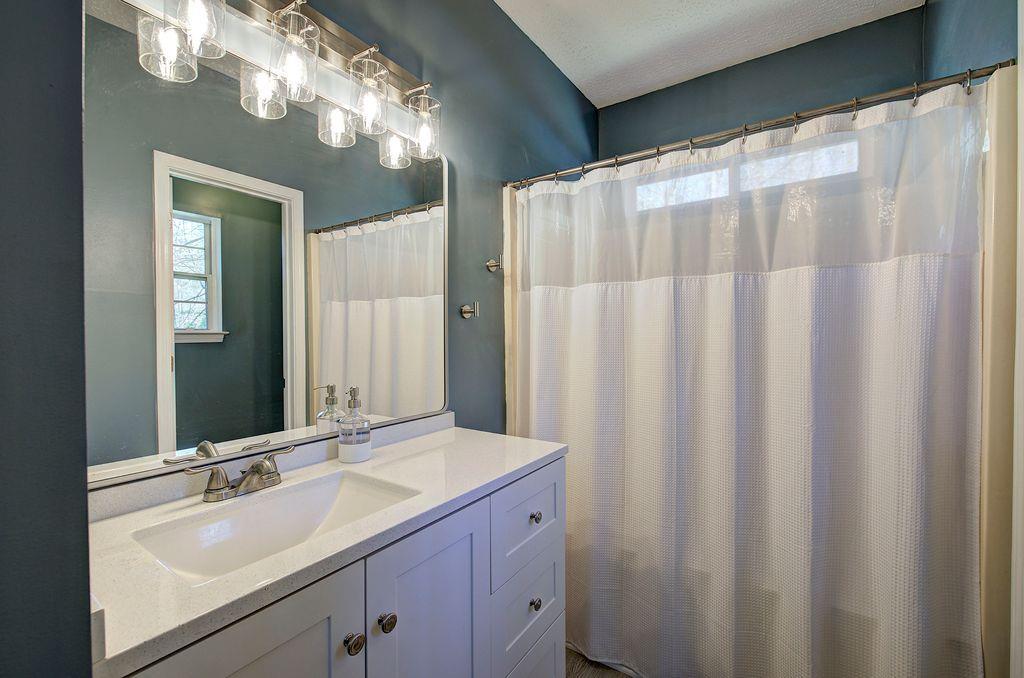 205 Cryder Lane Canton, GA 30115 - Photo 19 of 38 a bathroom with a double vanity sink and a mirror