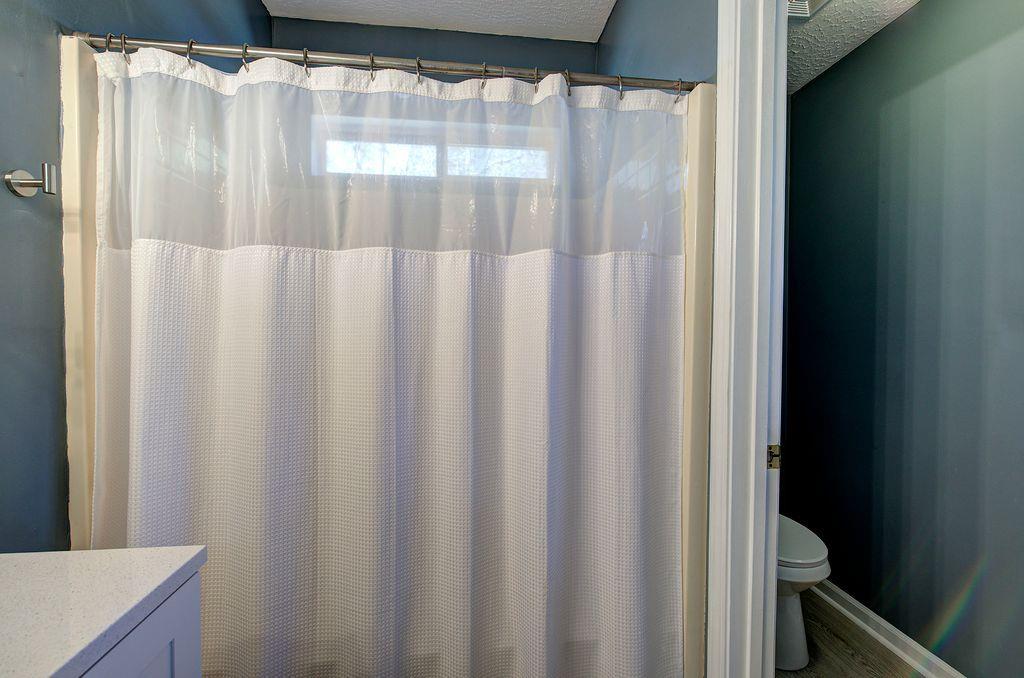 205 Cryder Lane Canton, GA 30115 - Photo 20 of 38 a bathroom with a shower and a curtain