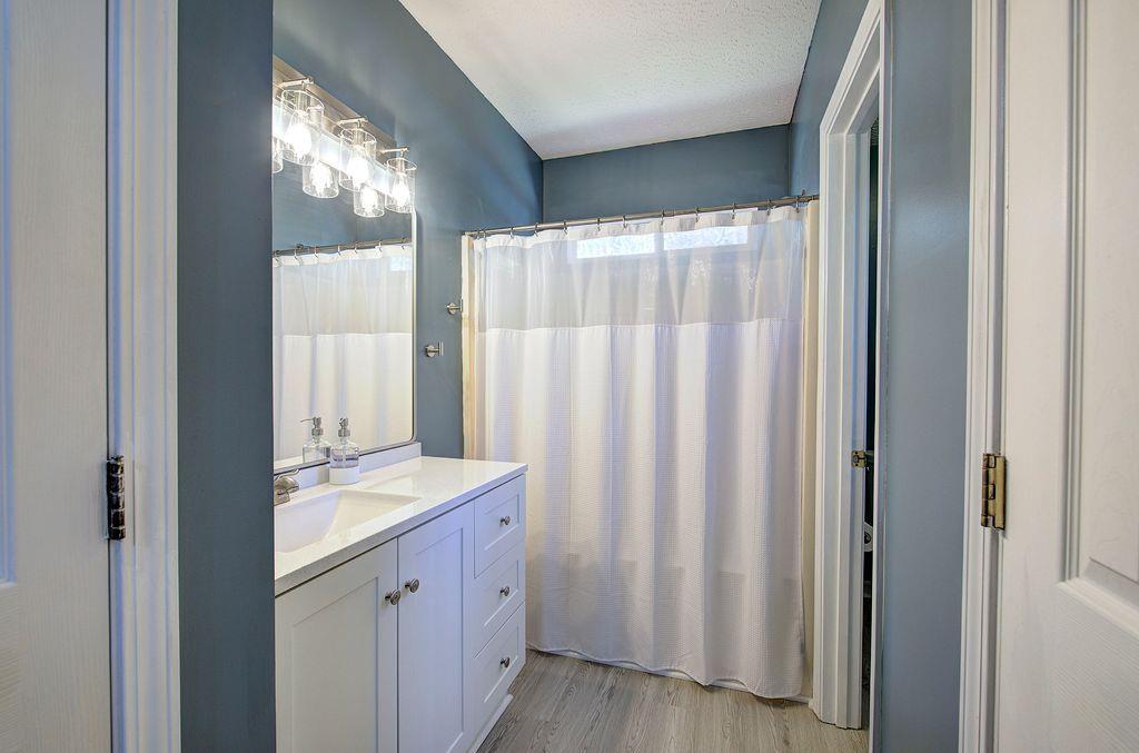 205 Cryder Lane Canton, GA 30115 - Photo 21 of 38 a bathroom with a sink a mirror and a shower curtain