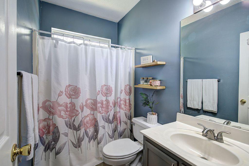 205 Cryder Lane Canton, GA 30115 - Photo 25 of 38 a bathroom with a sink toilet and shower