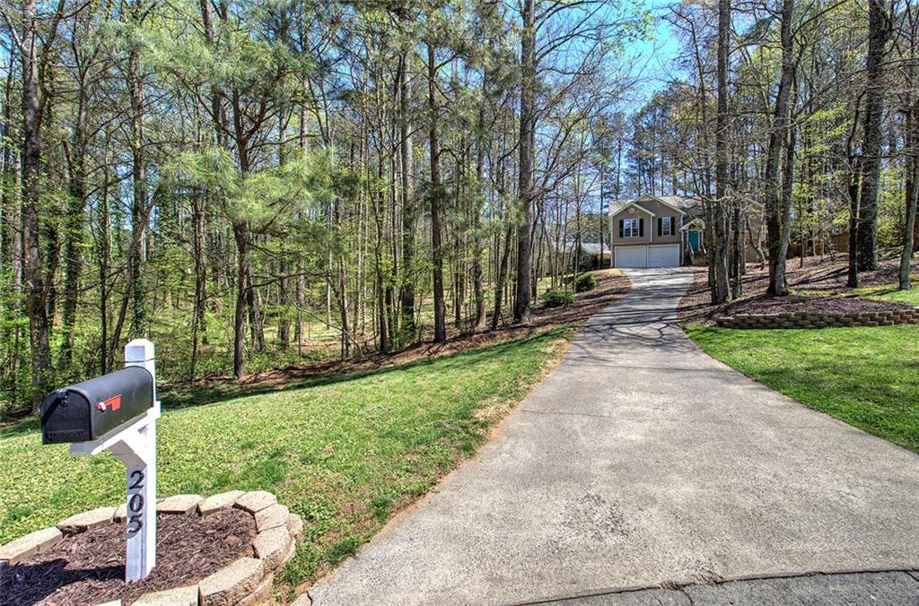 205 Cryder Lane Canton, GA 30115 - Photo 3 of 38 a pathway of a house with a yard and sitting area